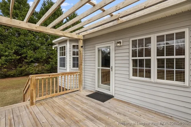 a view of a house with a wooden deck