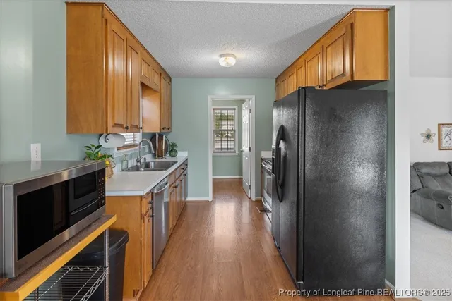 a kitchen with a sink cabinets and window