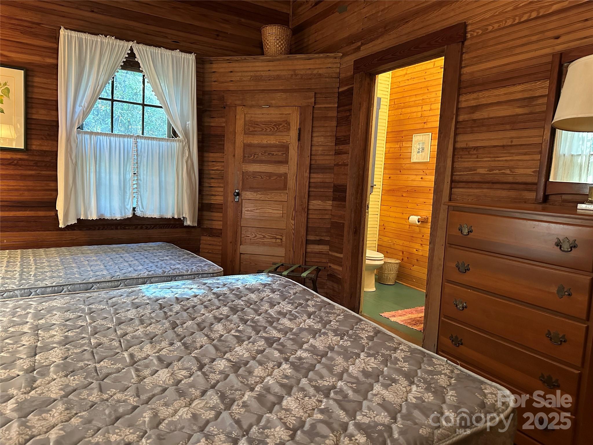16 Osborn Knob Road Marion, NC 28752 - Photo 35 of 48 a bedroom with a bed and two windows