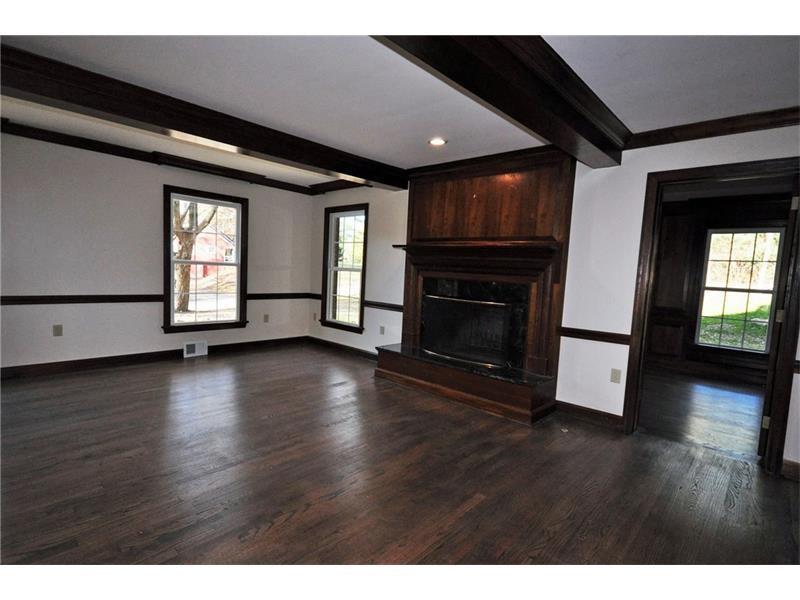 214 Highland Road Pittsburgh, PA 15238 - Photo 8 of 23 Massive family room featuring a fireplace, beamed ceilings and hardwood floors, chair railings is a great relaxation area in the center of the home. Convenient to kitchen and office and living and sun rooms.