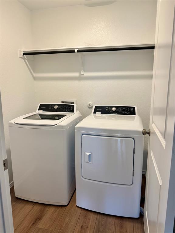 373 Jeffers Kyle, TX 78640 - Photo 12 of 26 Laundry area featuring light wood-style floors and separate washer and dryer