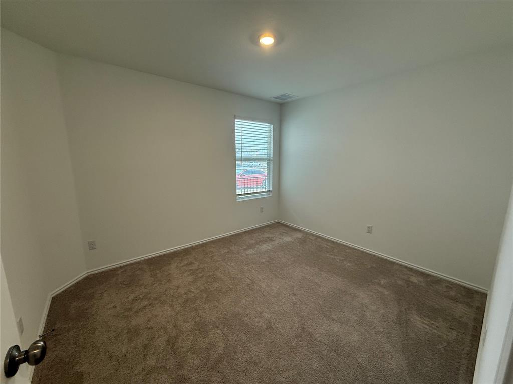 373 Jeffers Kyle, TX 78640 - Photo 15 of 26 Unfurnished room with dark carpet and baseboards