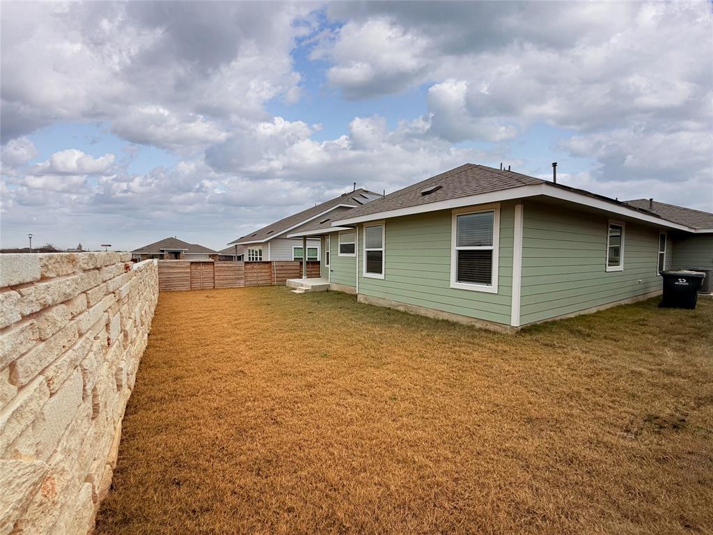 373 Jeffers Kyle, TX 78640 - Photo 20 of 26 Rear view of property with a fenced backyard and a shingled roof