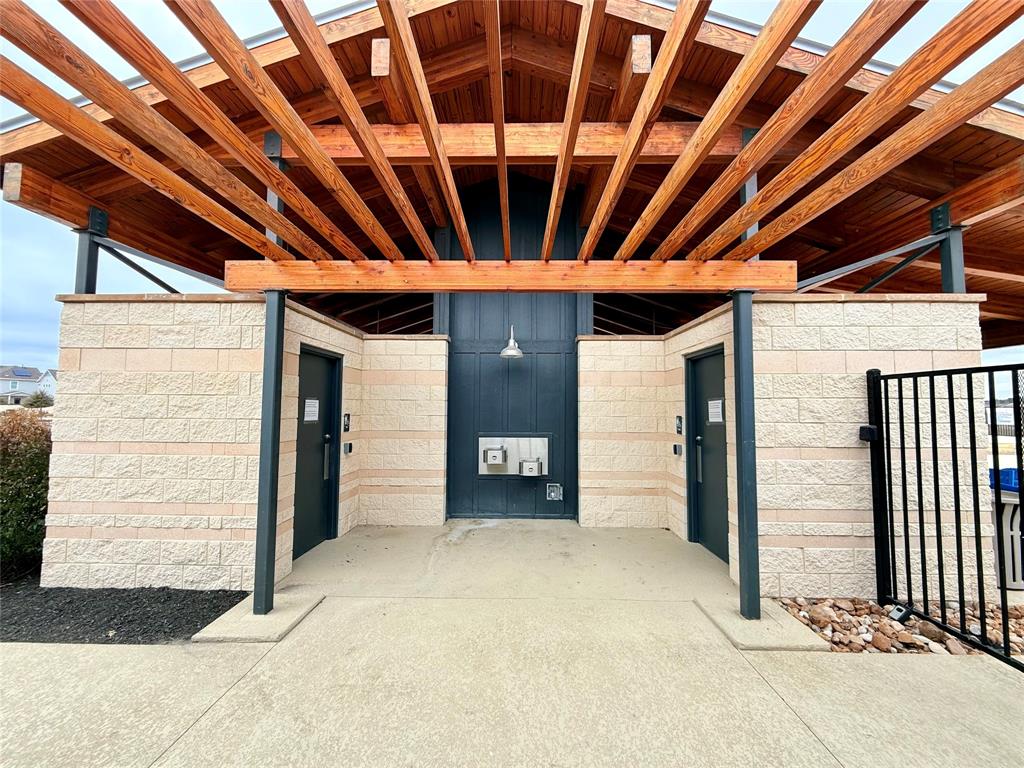 373 Jeffers Kyle, TX 78640 - Photo 22 of 26 View of exterior entry with a pergola, a patio, and concrete block siding