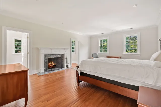 a spacious bedroom with a bed and a fireplace