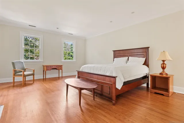 a bedroom with furniture and a wooden floor
