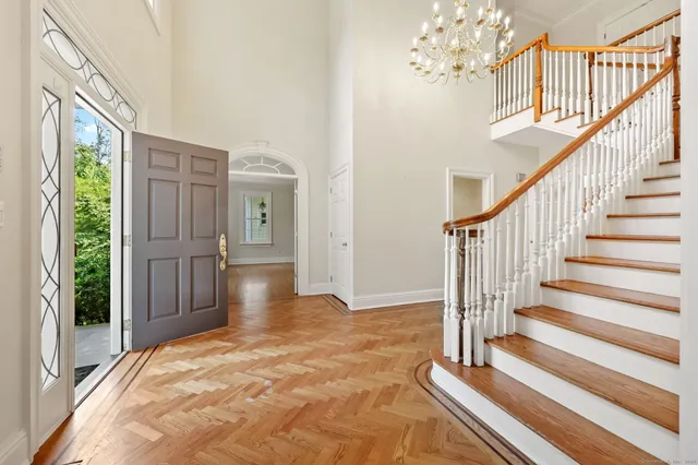 a view of an entryway with wooden floor and door