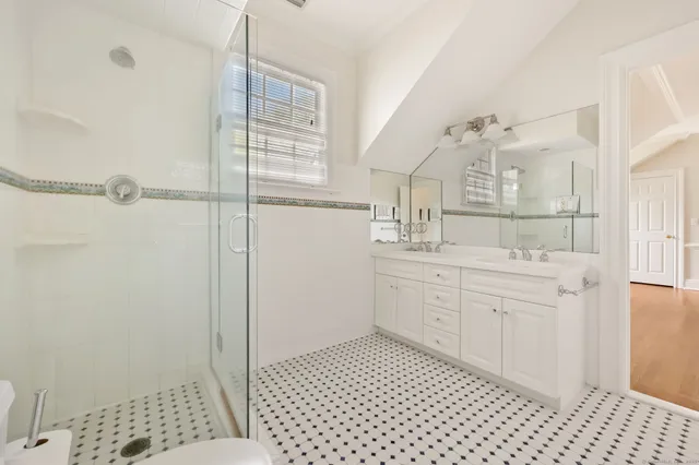a bathroom with a sink a mirror and a shower