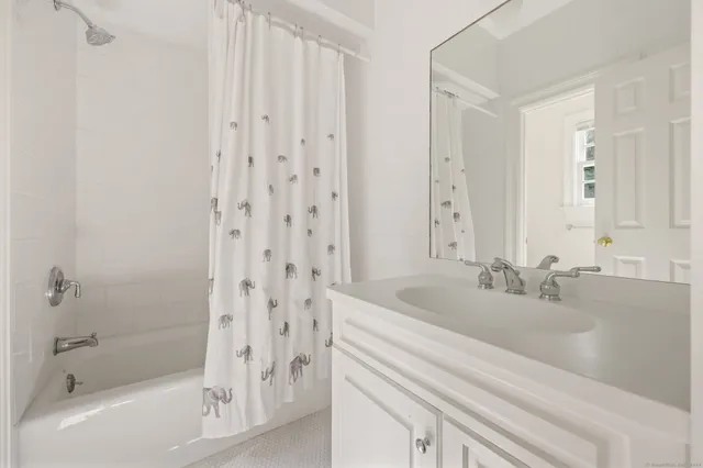 a bathroom with a bathtub and a sink