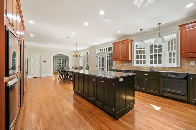 a kitchen with stainless steel appliances granite countertop a stove a sink and a refrigerator