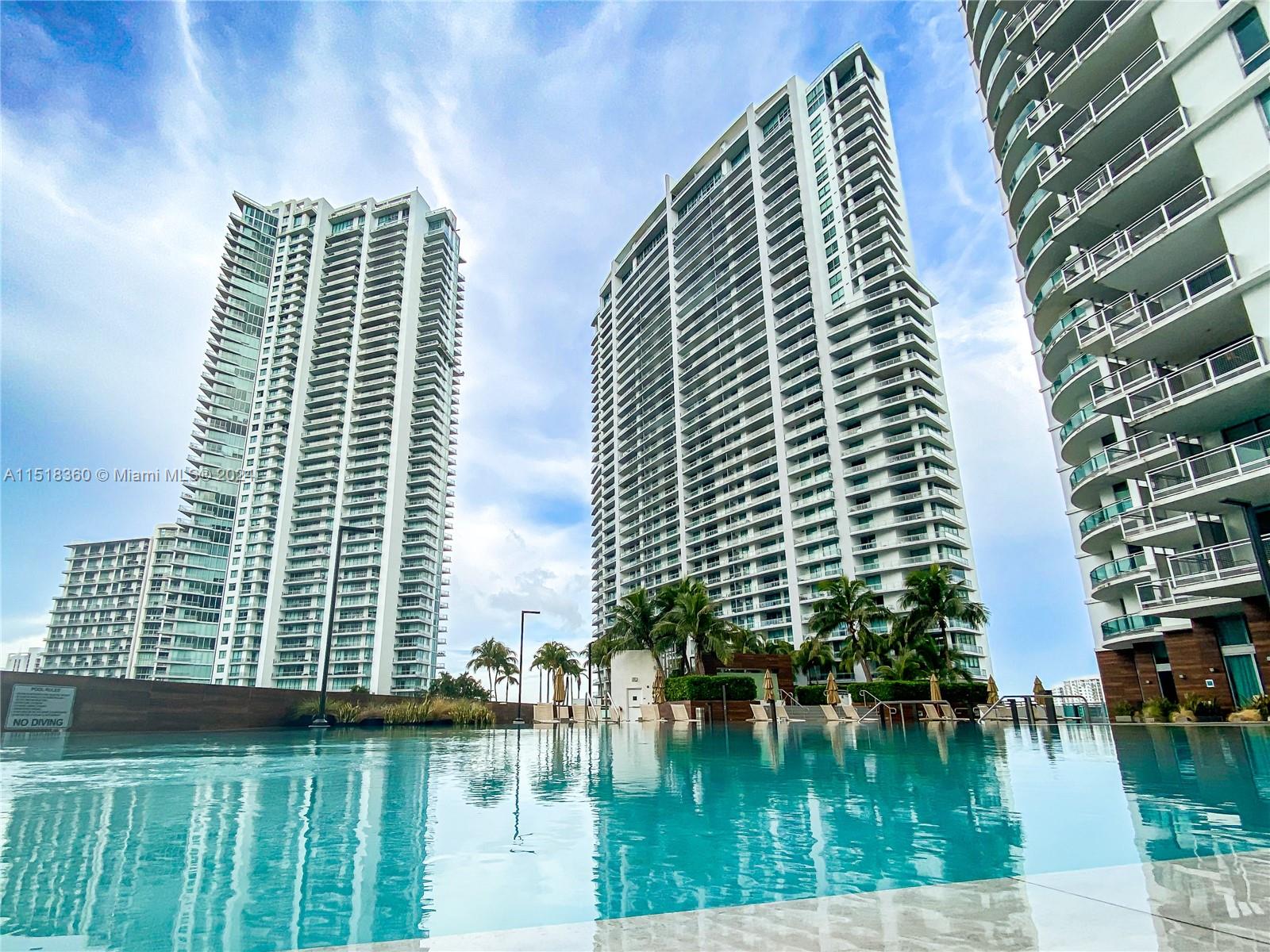 a view of swimming pool with tall buildings