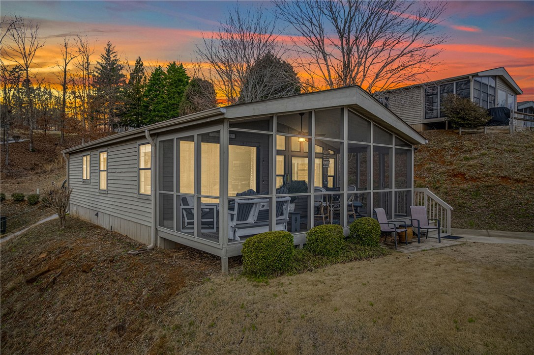 This captivating residence boasts a comfortable screened porch, ideal for relaxation.