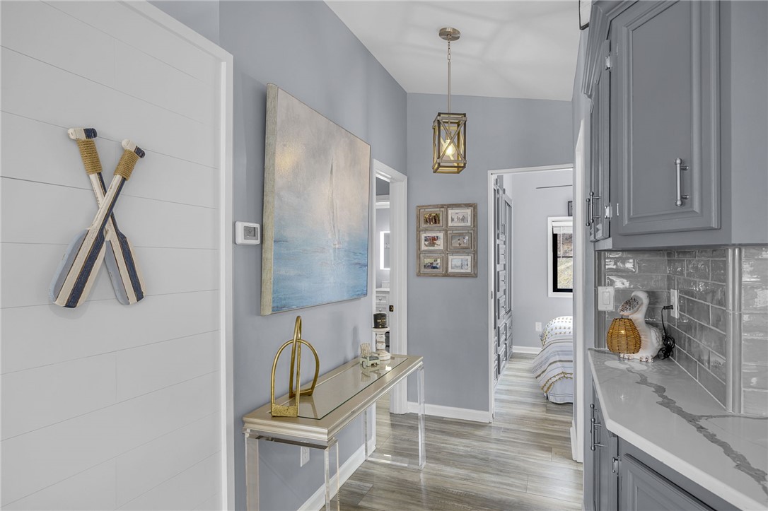 1230 Melton Road, Unit 15 West Union, SC 29696 - Photo 17 of 50 This inviting hallway features sleek grey cabinetry and durable flooring, connecting spaces with modern appeal.