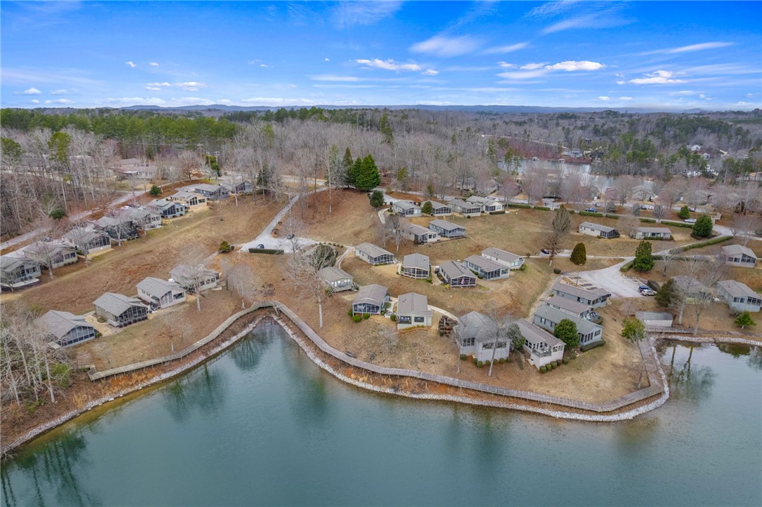 1230 Melton Road, Unit 15 West Union, SC 29696 - Photo 31 of 50 This aerial view showcases a serene lake community nestled among rolling hills.