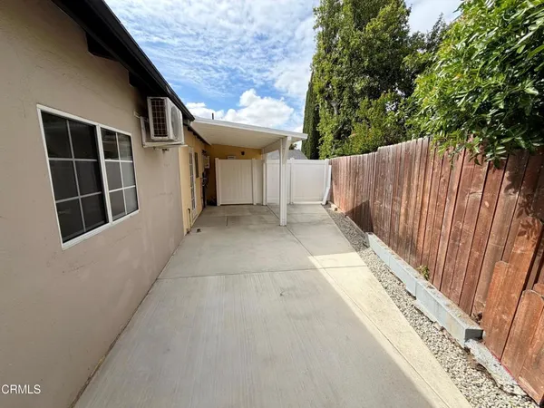a view of backyard with small cabin and wooden fence