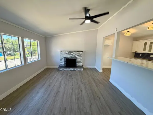 a view of a livingroom with a fireplace and wooden floor