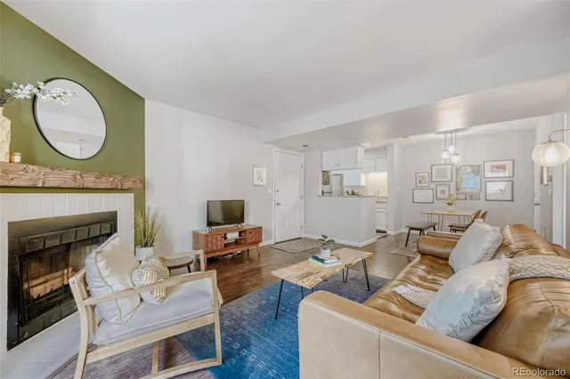 a living room with furniture a mirror and a fireplace