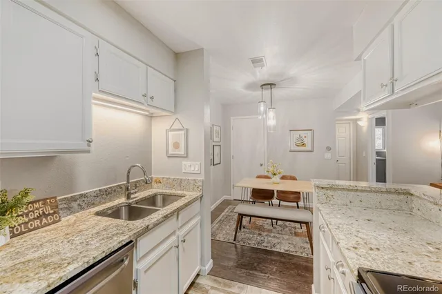 a kitchen with a sink a counter space and appliances