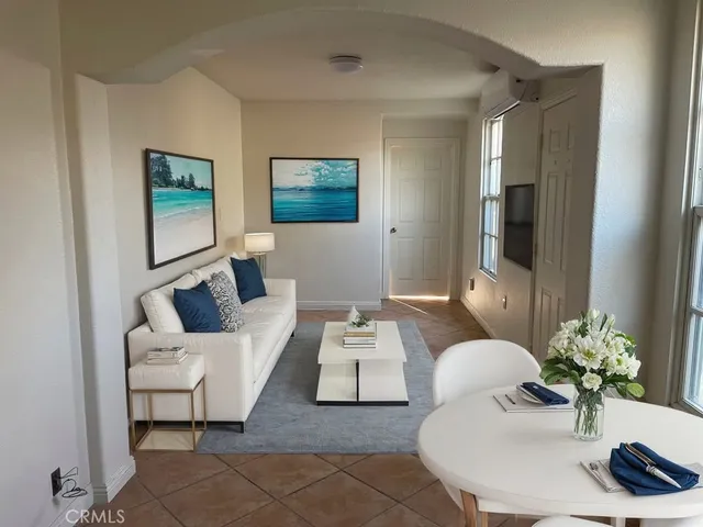 a living room with furniture and a potted plant