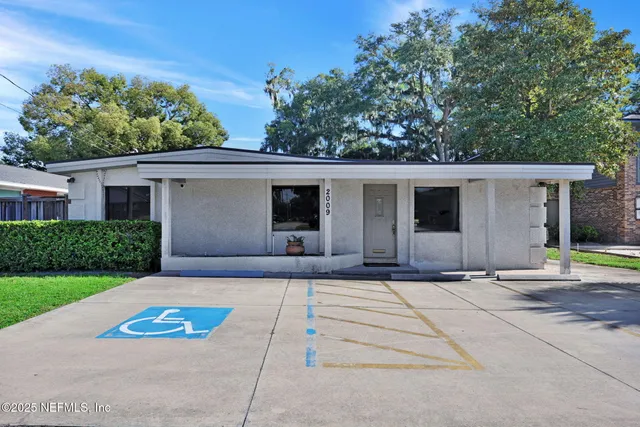 a front view of a house with a yard and a garage