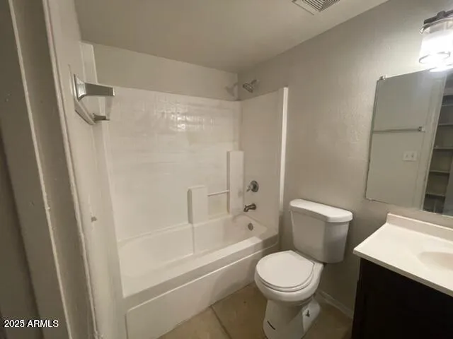 a white toilet sitting next to a bath tub