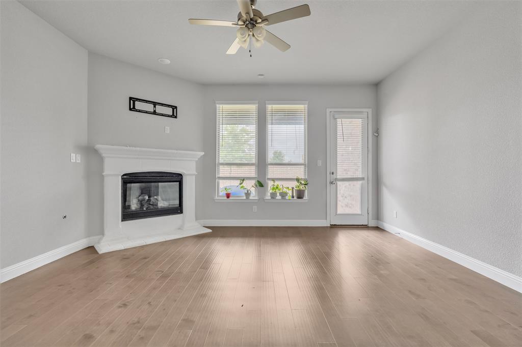 1802 Graham Way Mansfield, TX 76063 - Photo 13 of 38 a view of an empty room with a fireplace and a window
