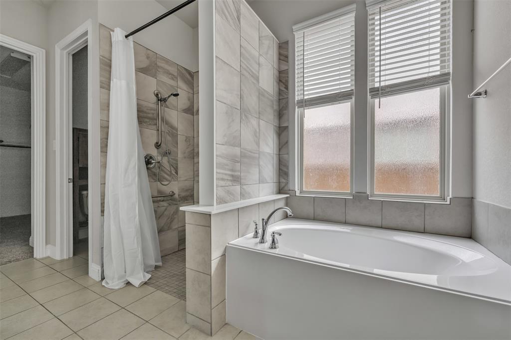 1802 Graham Way Mansfield, TX 76063 - Photo 18 of 38 a bathroom with a tub and a shower