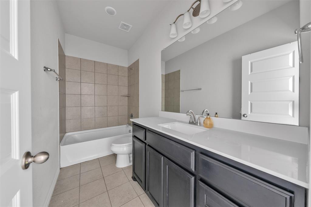 1802 Graham Way Mansfield, TX 76063 - Photo 29 of 38 a bathroom with a granite countertop sink a toilet and bathtub