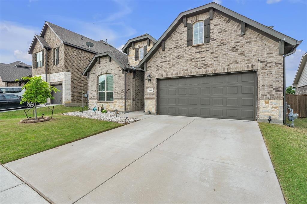 1802 Graham Way Mansfield, TX 76063 - Photo 3 of 38 a front view of a house with a yard and garage