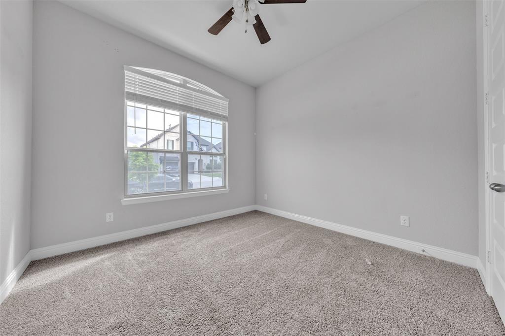 1802 Graham Way Mansfield, TX 76063 - Photo 5 of 38 an empty room with a window and a fan