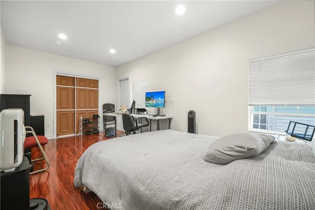 a large bedroom with two beds and a desk