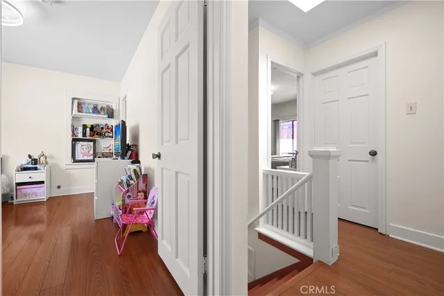 a bed sitting in a spacious bedroom next to a window