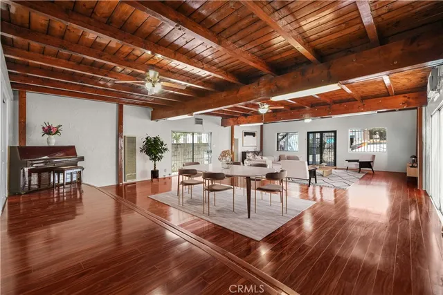 a dining room with lots of wooden furniture and wooden floor