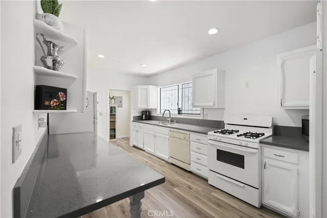 a kitchen with white cabinets and white appliances