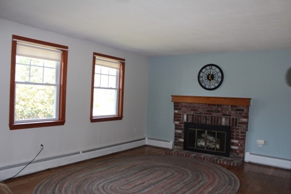 62 Edward Road Townsend, MA 01469 - Photo 8 of 14 a view of an empty room with wooden floor fireplace and a window