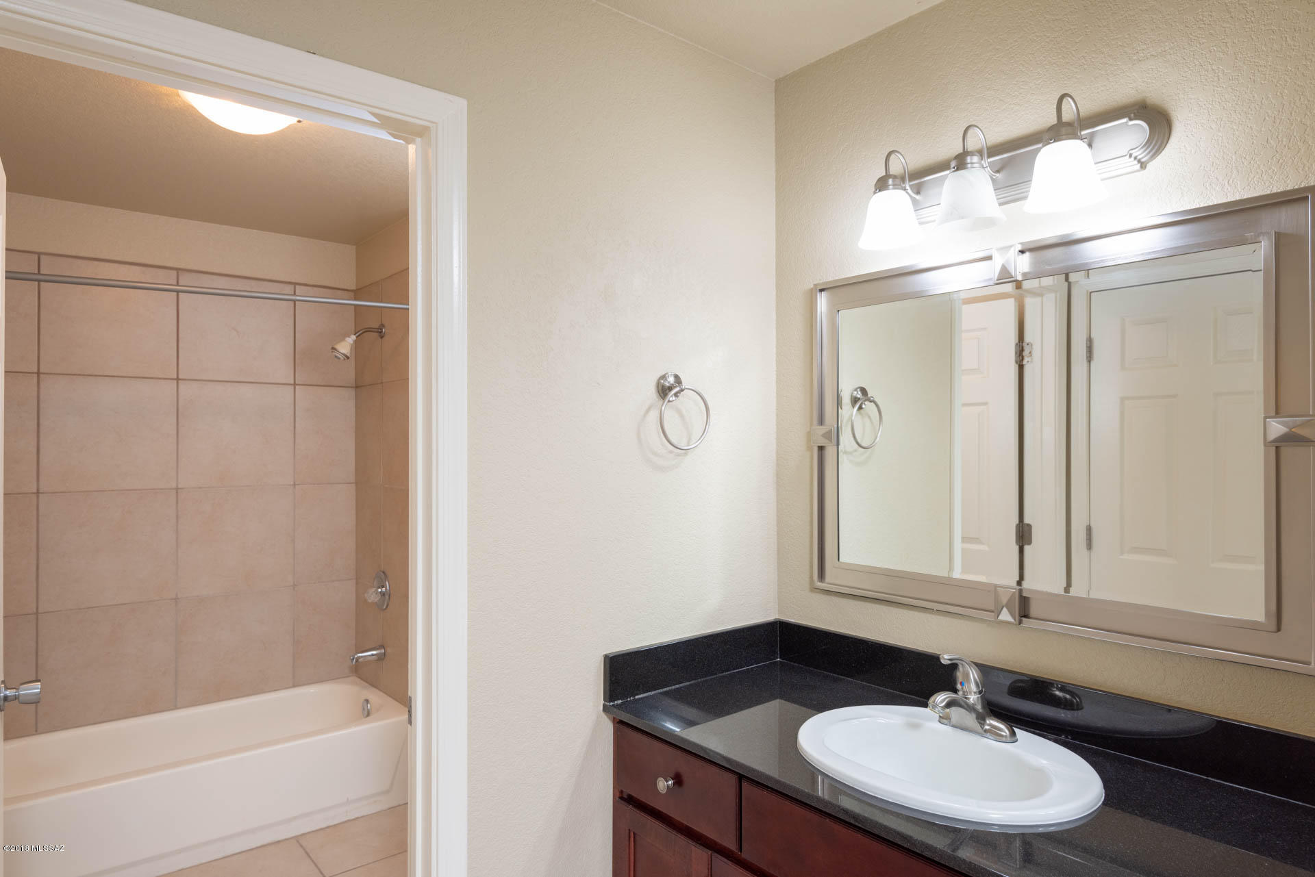 7255 East Snyder Road, Unit 8205 Tucson, AZ 85750 - Photo 9 of 23 a bathroom with a sink and a mirror