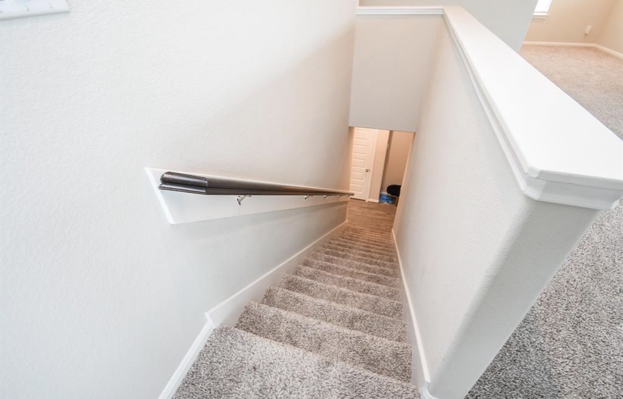 6927 Ventura Drive Rosharon, TX 77583 - Photo 17 of 20 Carpeted stairs provide added comfort and safety while creating a soft, quiet transition between levels. A practical feature for everyday living, especially for families.