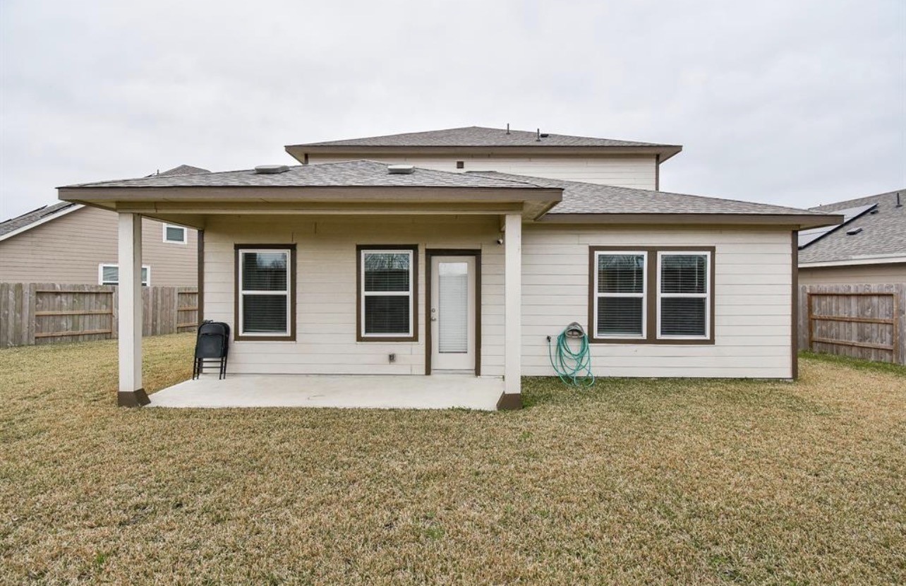 6927 Ventura Drive Rosharon, TX 77583 - Photo 19 of 20 Covered back patio offering a comfortable outdoor space for relaxing or entertaining. Ideal for enjoying fresh air year-round while overlooking the backyard, making it a great extension of the home’s living space.