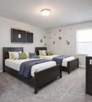 a bedroom with two beds and a couch