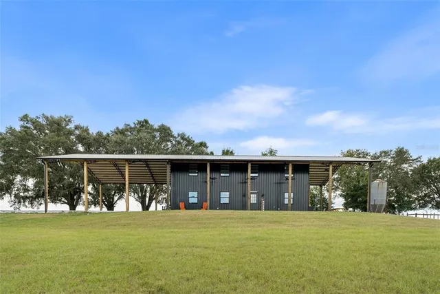 a front view of house with a garden and balcony