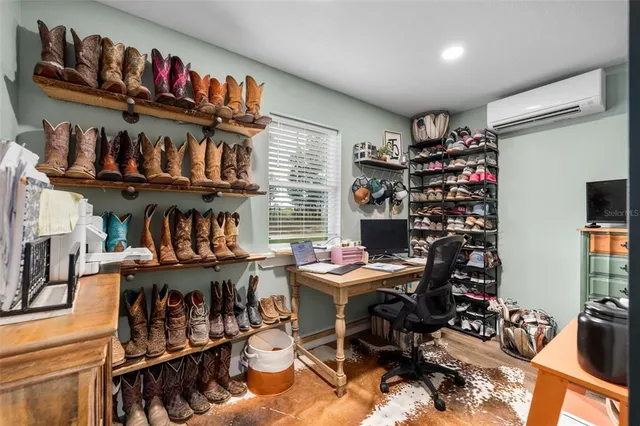 a room with lots of books and a large window