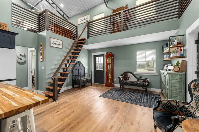 a view of a livingroom with furniture and staircase