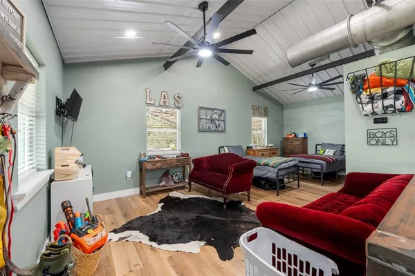 a living room with furniture a couch and a ceiling fan