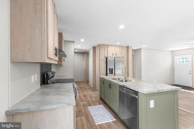 a kitchen with stainless steel appliances granite countertop a sink stove and cabinets
