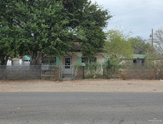 a small house with a tree in front of it