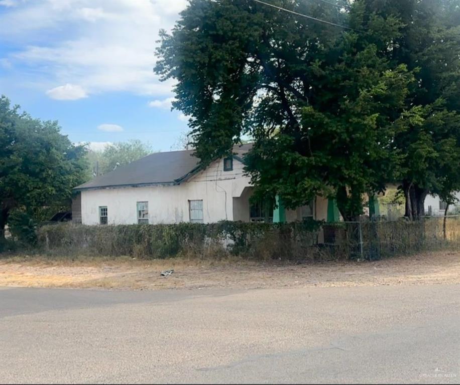 a view of a house with a large tree