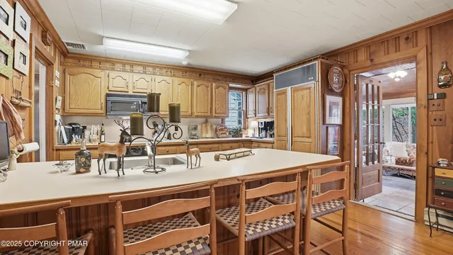 a kitchen with a sink a counter top space and stainless steel appliances