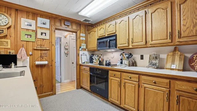 a kitchen with stainless steel appliances granite countertop a refrigerator and cabinets