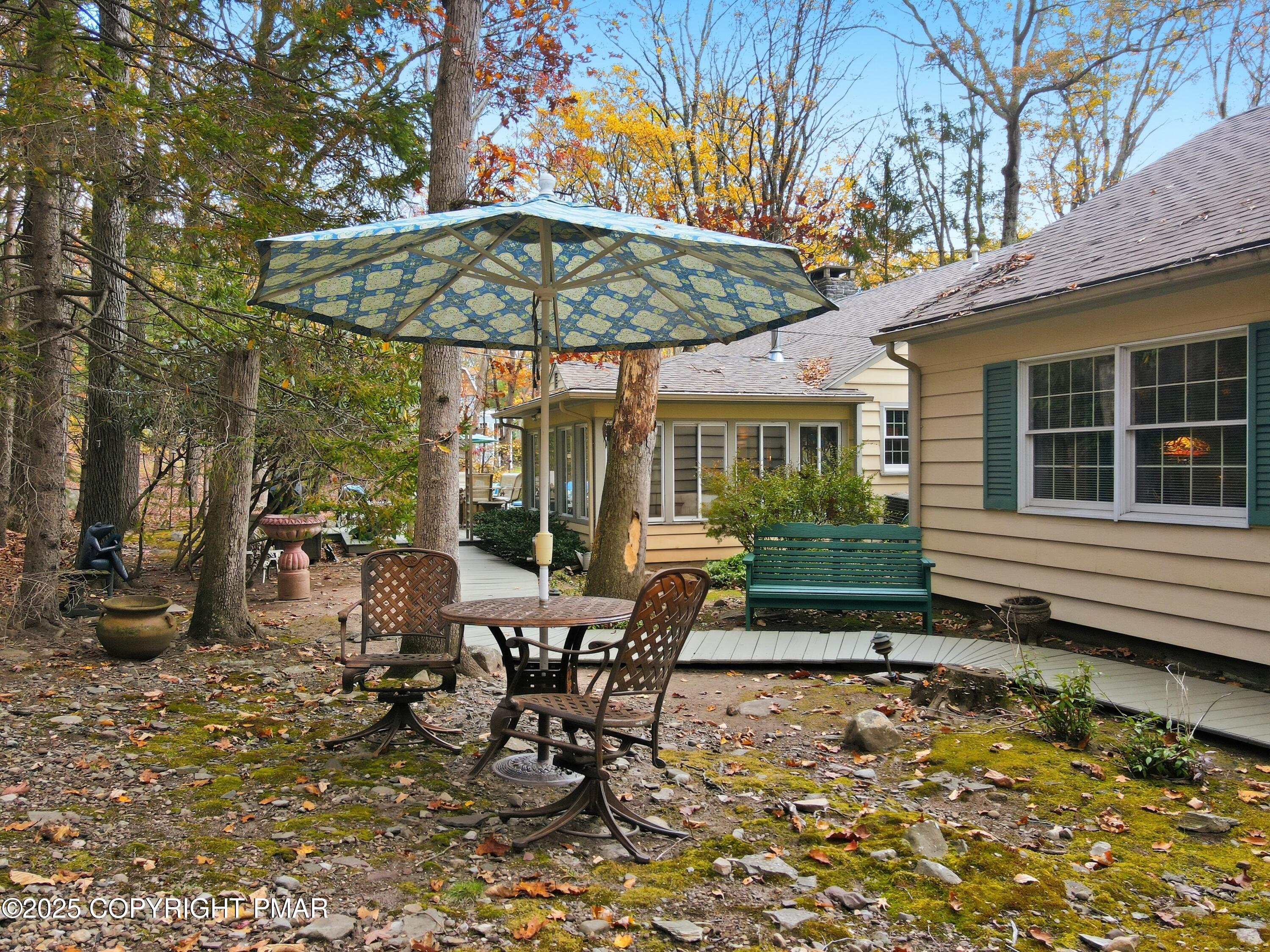 519 Pheasant Lane Cresco, PA 18326 - Photo 59 of 79 a view of a patio with a table and chairs under an umbrella