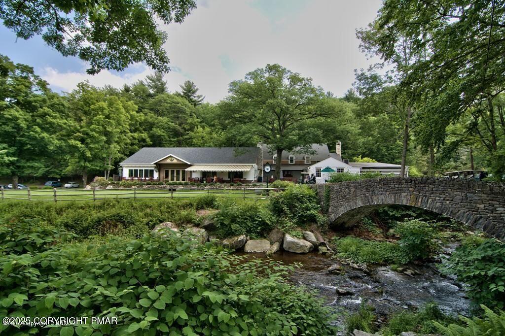 519 Pheasant Lane Cresco, PA 18326 - Photo 73 of 79 a view of a house with a yard and potted plants